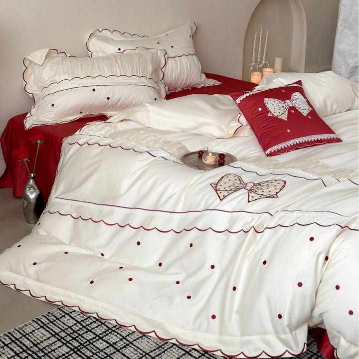 Elegant cotton satin bedding set with decorative bow appliqué and gathered frill