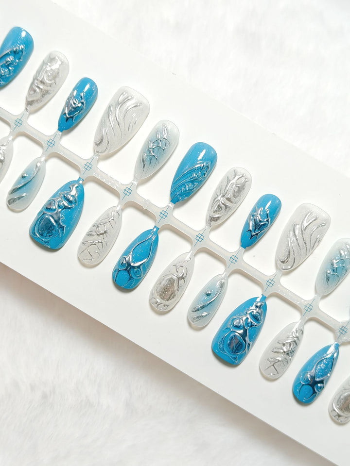 Creative artificial nails with shiny silver and turquoise tones Stornfield