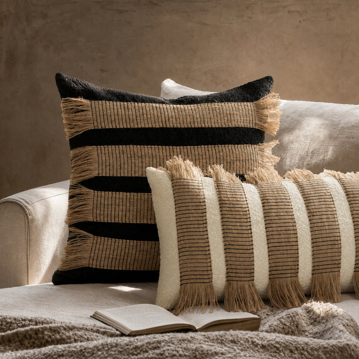 Woven cushion cover with bouclé surface and jute fringes Stornfield