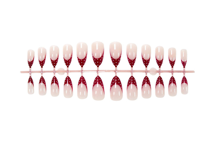 Nail art set with elegant red tips and playful dots Stornfield