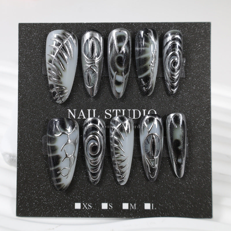 Artificial nail set with modern spiral pattern and shiny accents Stornfield