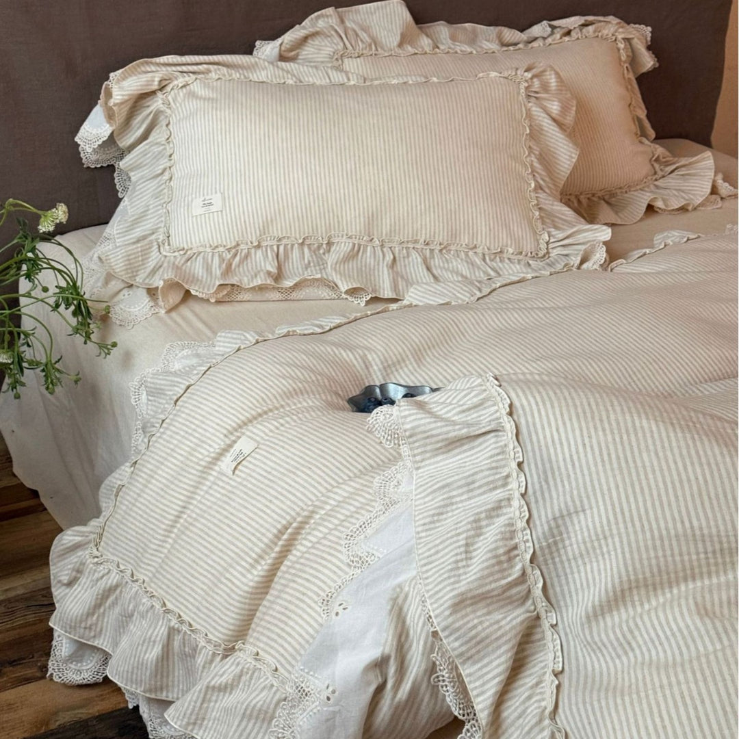 Country house style bed linen set with ruffles, lace border and quilted bedspread