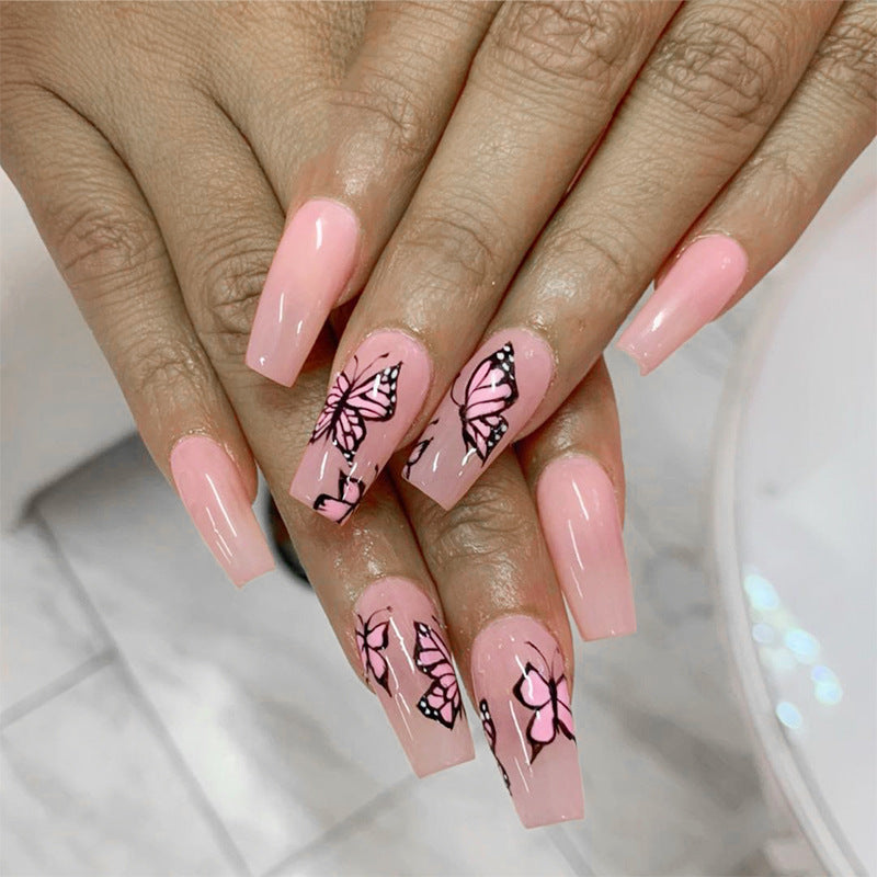 Artful acrylic nails with dynamic butterfly design Stornfield