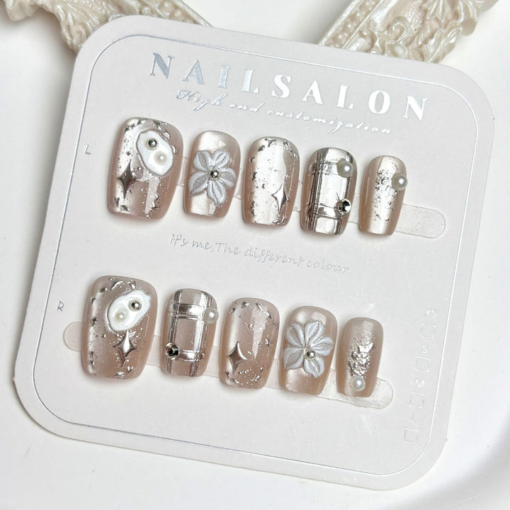 Artistic Press-On Nail Set with Floral and Metallic Accents
