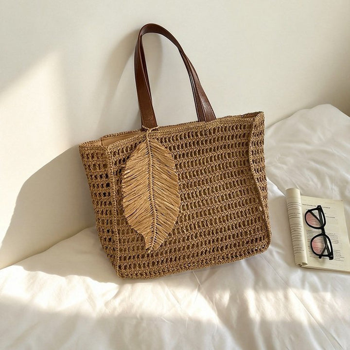 Handbag made of hand-woven natural material with decorative leaf shape design Stornfield
