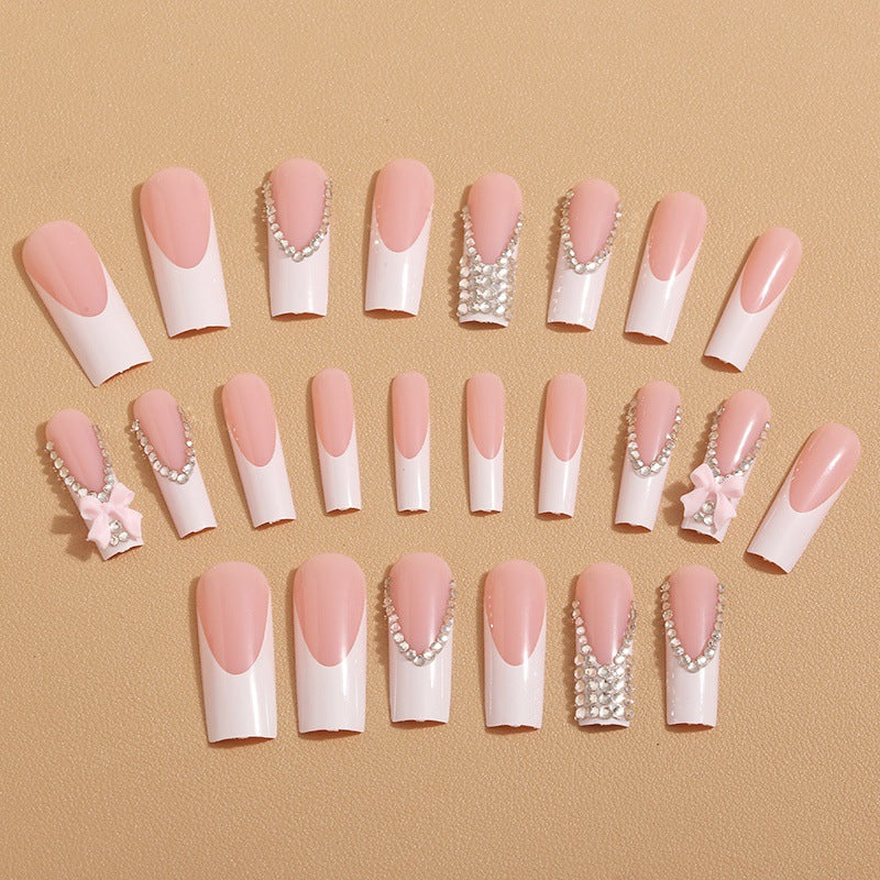 Artificial nails with glamorous rhinestone decorations and floral accents Stornfield