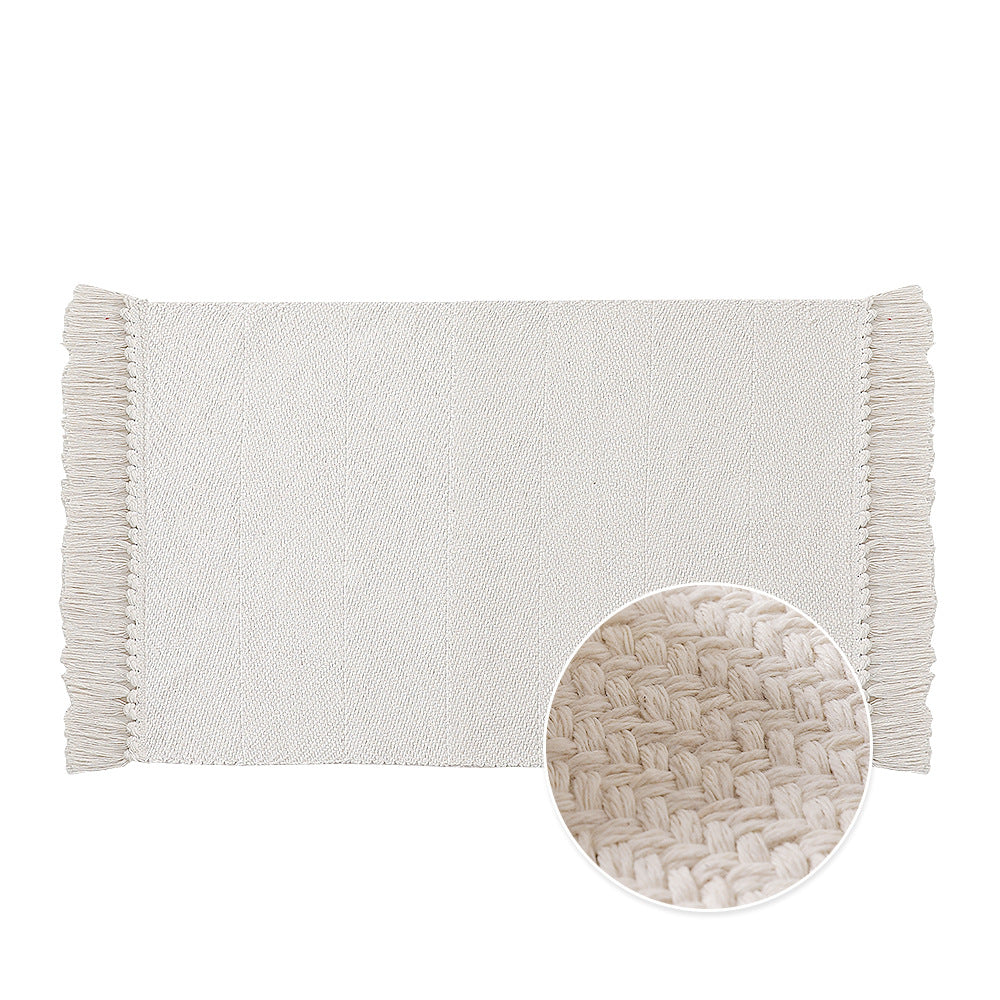 Handwoven table runner in herringbone pattern with decorative fringes