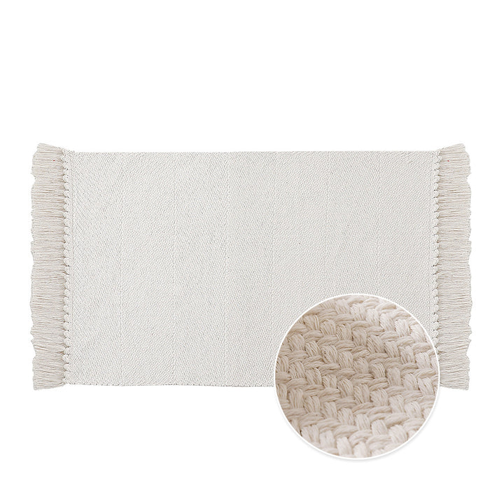 Handwoven table runner in herringbone pattern with decorative fringes