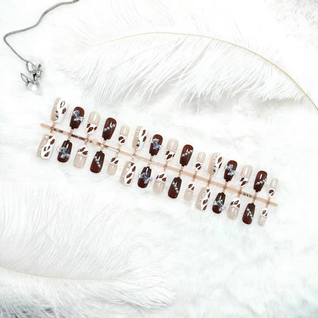 Artificial nails with sparkling rhinestone and bow accents Stornfield