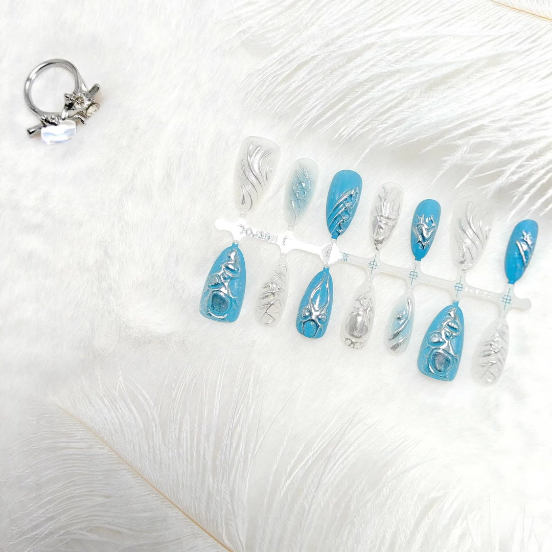 Creative artificial nails with shiny silver and turquoise tones Stornfield
