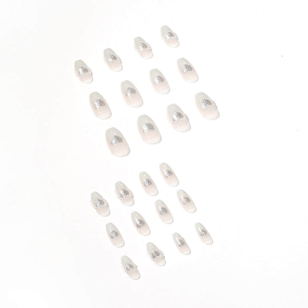Artificial nail art with heart and rhinestone decorations Stornfield