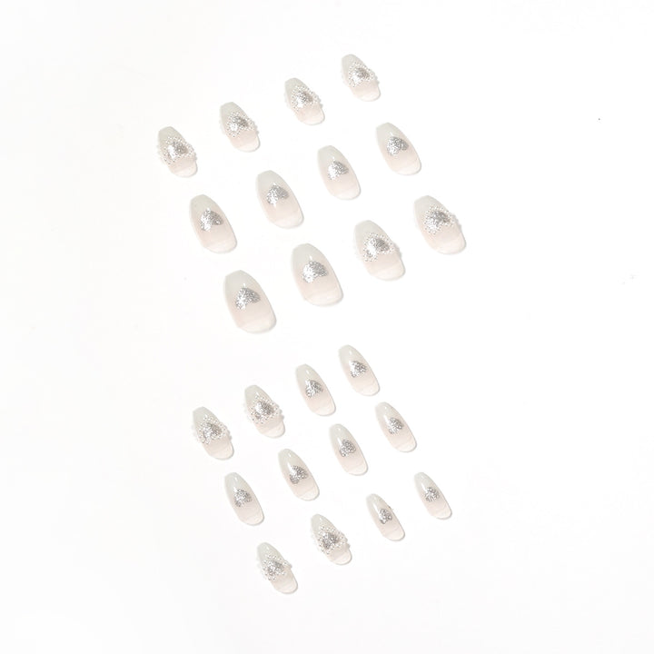 Artificial nail art with heart and rhinestone decorations Stornfield