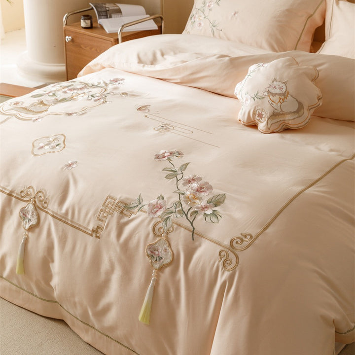 Luxurious cotton satin bedding set with fine embroidery, floral motifs, and decorative pillows