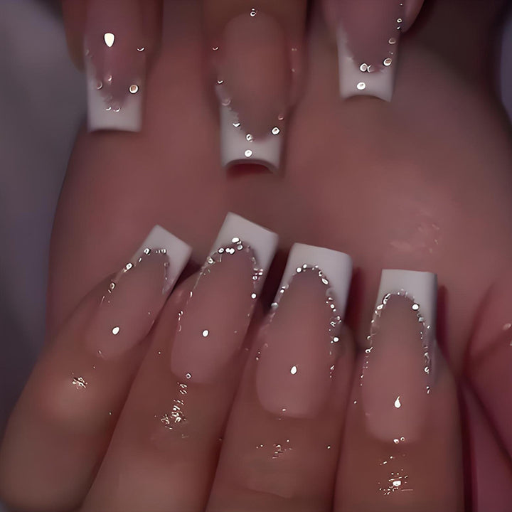 Artificial nail set with elegant French tip and glitter accents Stornfield