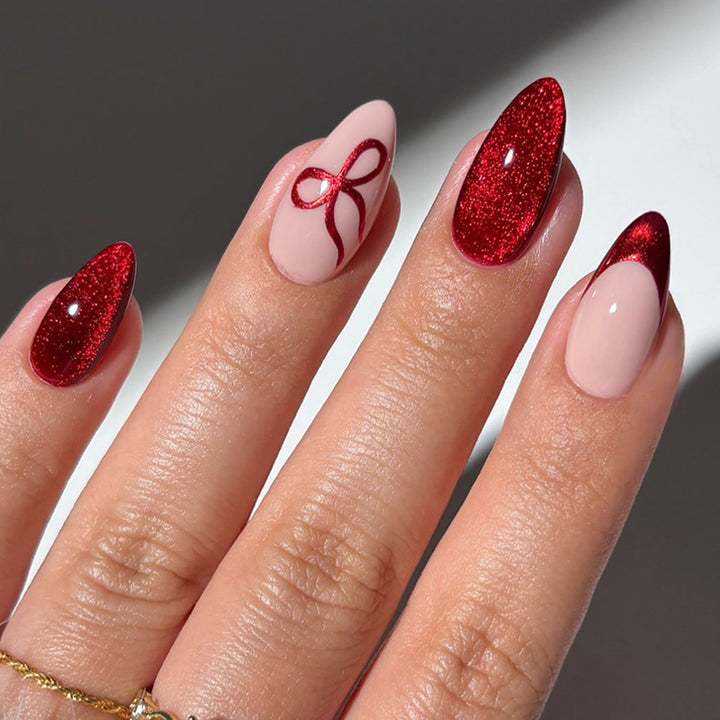 Artificial nail set with elegant red and delicate bow accents Stornfield