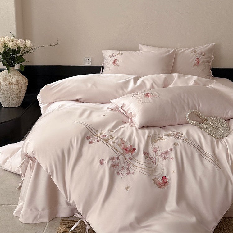 Satin bedding set with floral embroidery, ribbon ties and silky surface