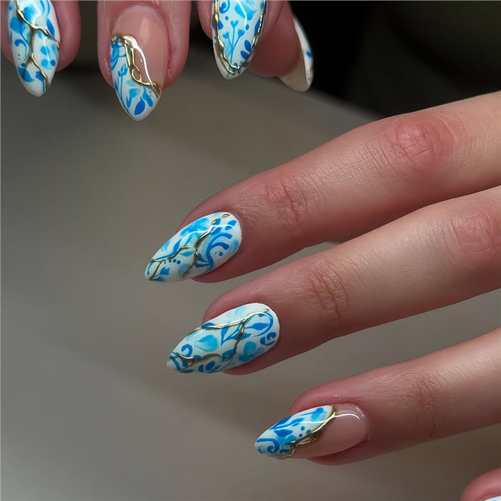 Artistic Floral Press-On Nail Design with Gold Accents Stornfield