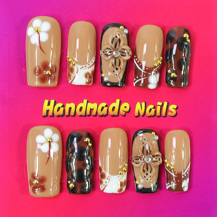 Acrylic nail set with elegant handcrafted designs and decorative accents Stornfield