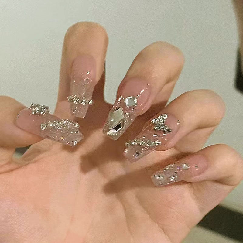 Glamorous artificial nails with sparkling rhinestones and elegant designs Stornfield