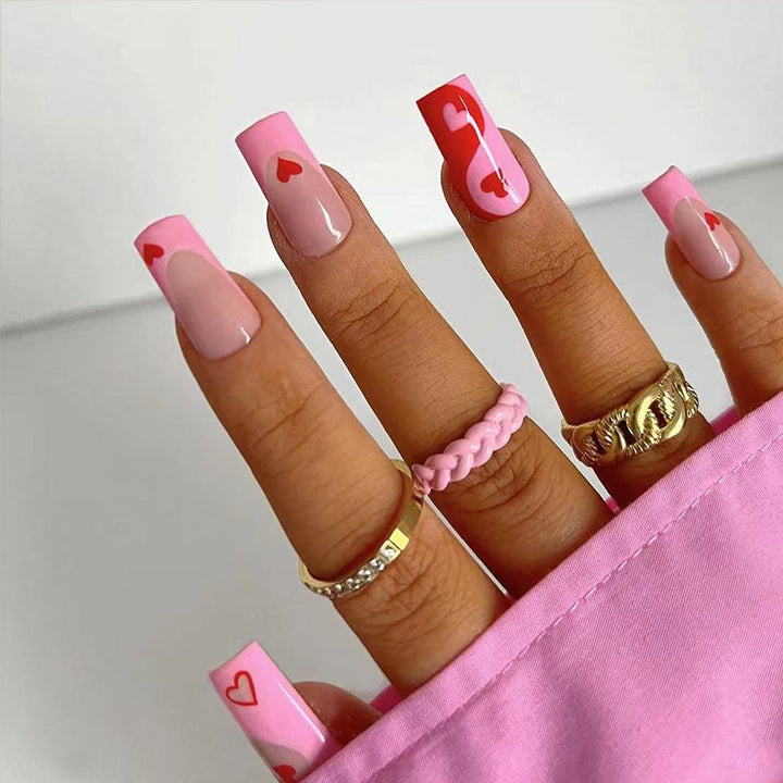 Artificial nail art with heart design and glitter accents Stornfield
