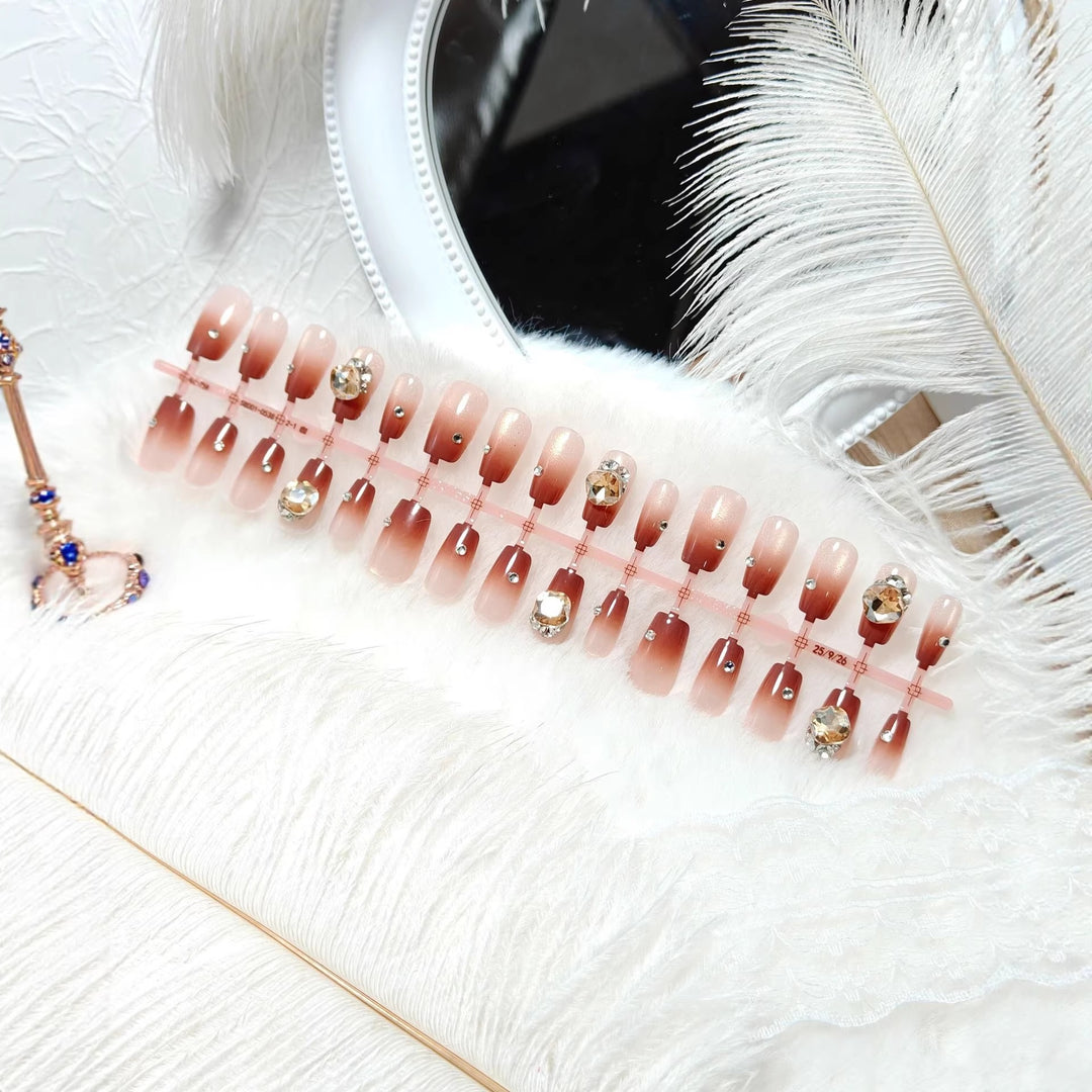 Artificials nails in elegant ombre style with rhinestone embellished applications Stornfield