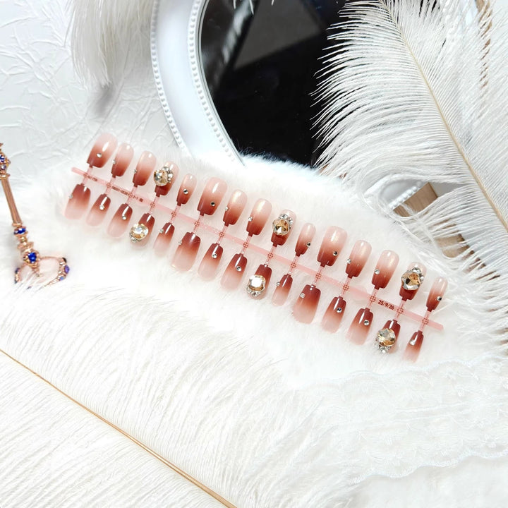 Artificials nails in elegant ombre style with rhinestone embellished applications Stornfield