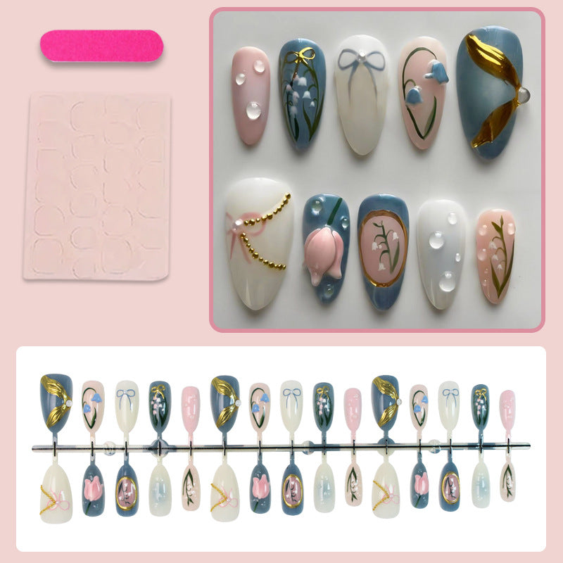 Acrylic nail set with floral design and elegant gold embellishments Stornfield