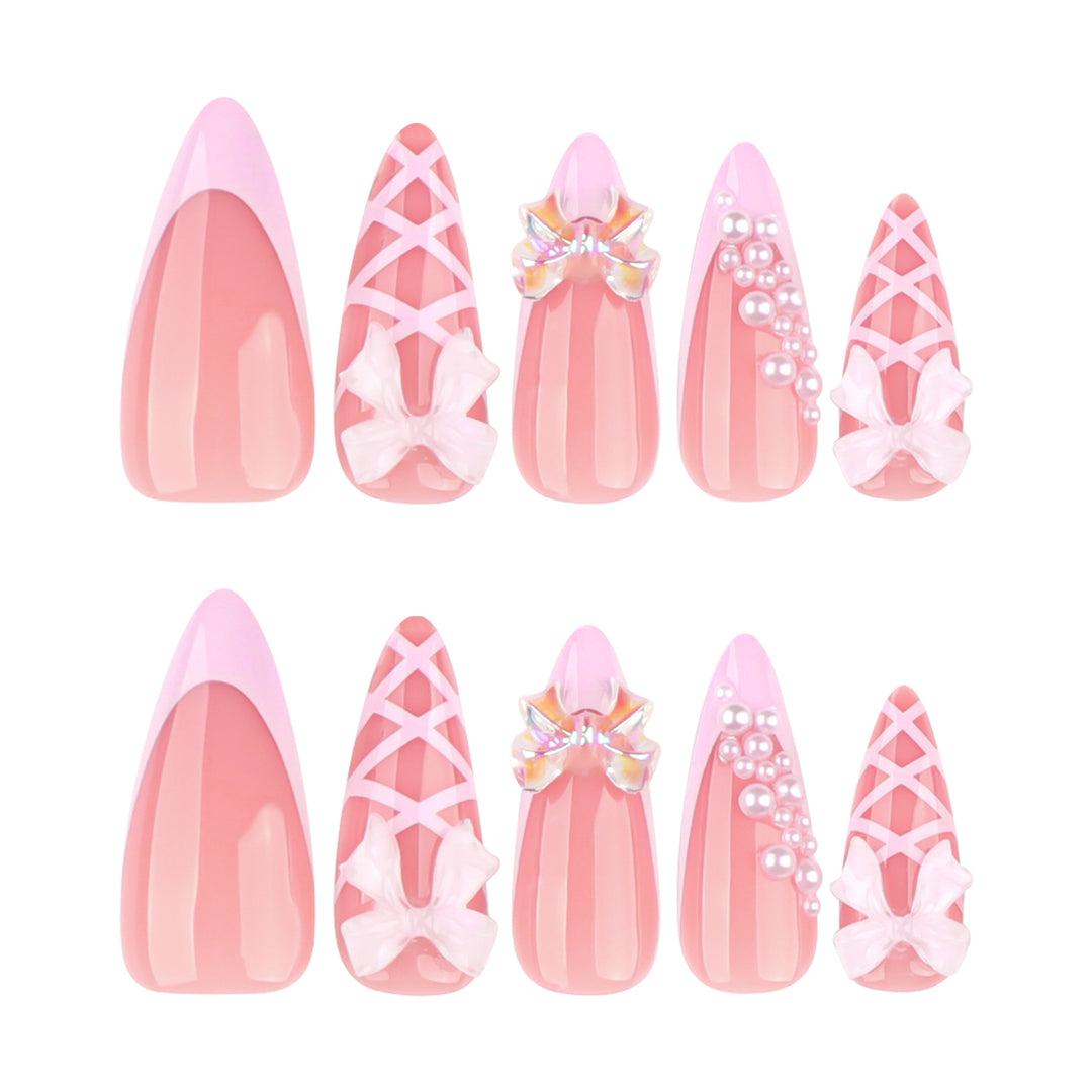Artful stiletto nails with glitter and bow decoration Stornfield