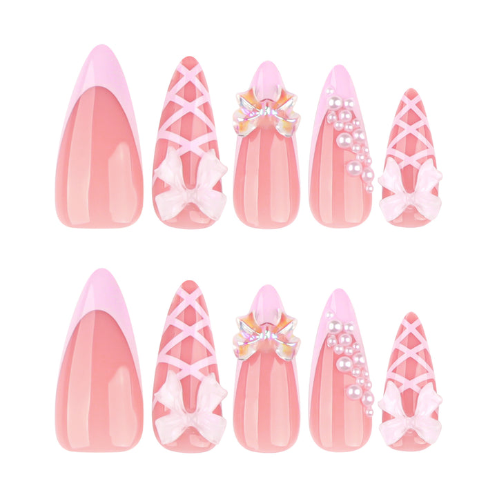 Artful stiletto nails with glitter and bow decoration Stornfield