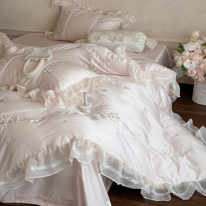 Satin bedding set with fine ruffle trim, delicate floral embroidery, and decorative pillowcases