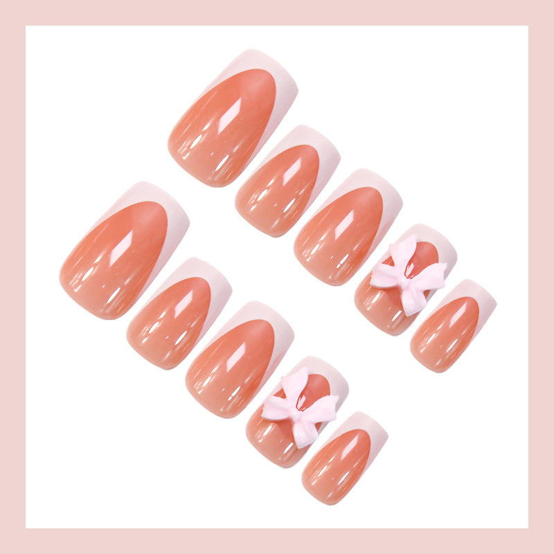 Acrylic nail set with elegant tips and playful bows Stornfield
