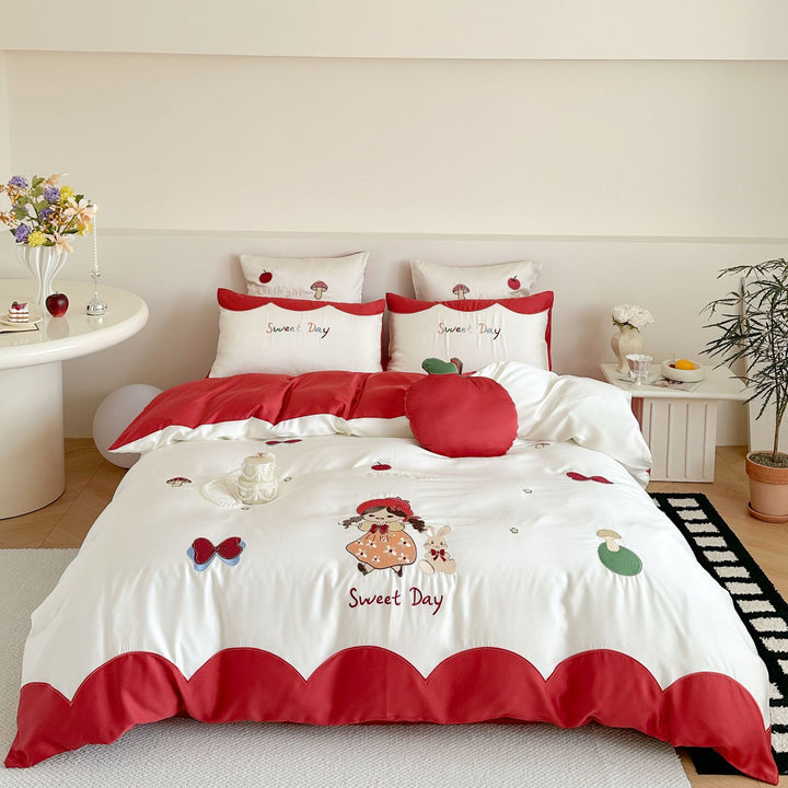 Bedding set with embroidered doll and apple motifs