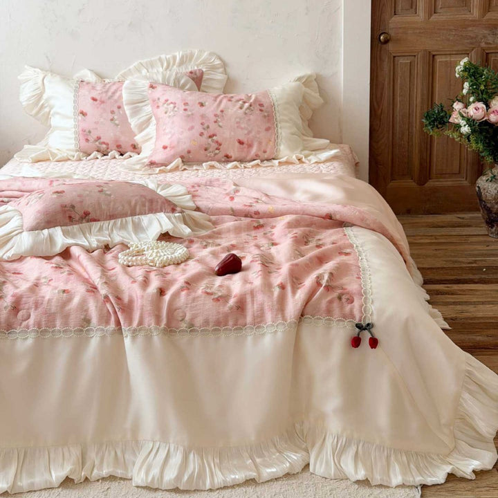 Romantic bedding set with ruffles, quilted bedspread, and decorative pillowcases