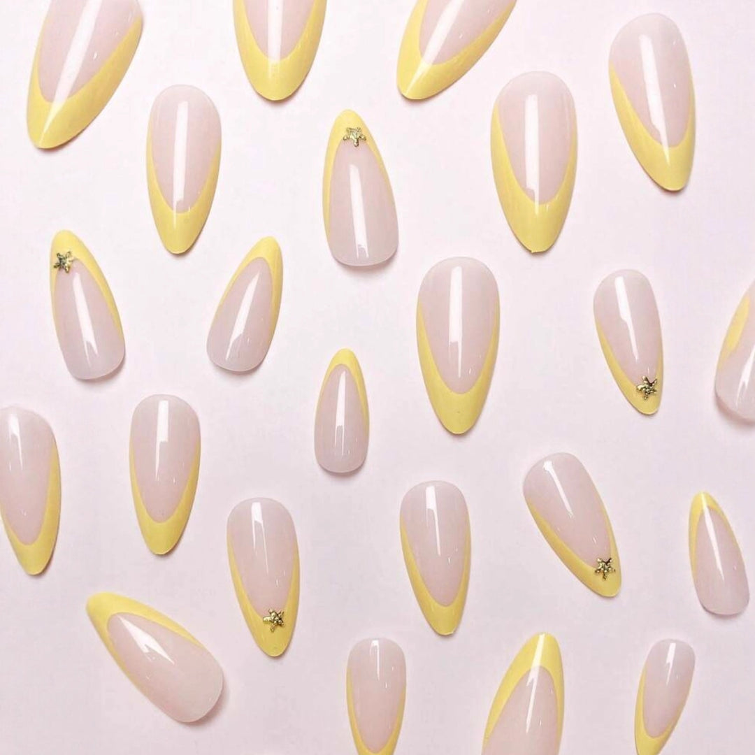 Artificial nail set with elegant tips and gold embellishments Stornfield