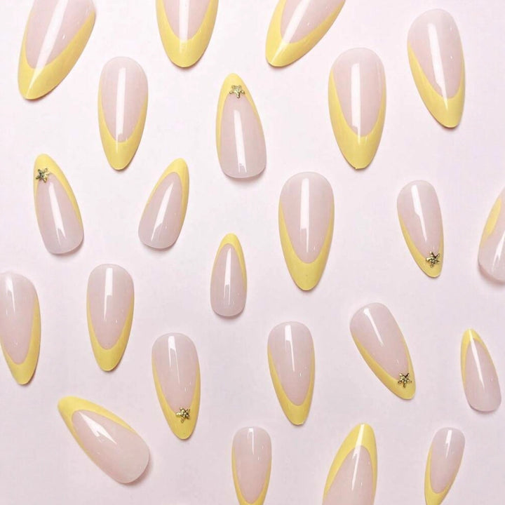 Artificial nail set with elegant tips and gold embellishments Stornfield