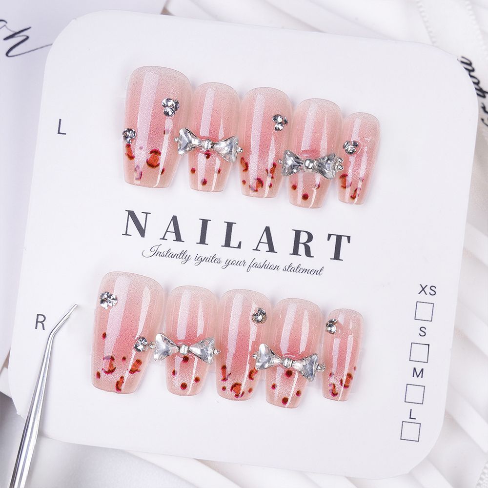 Art nails with delicate rhinestone and bow accents Stornfield