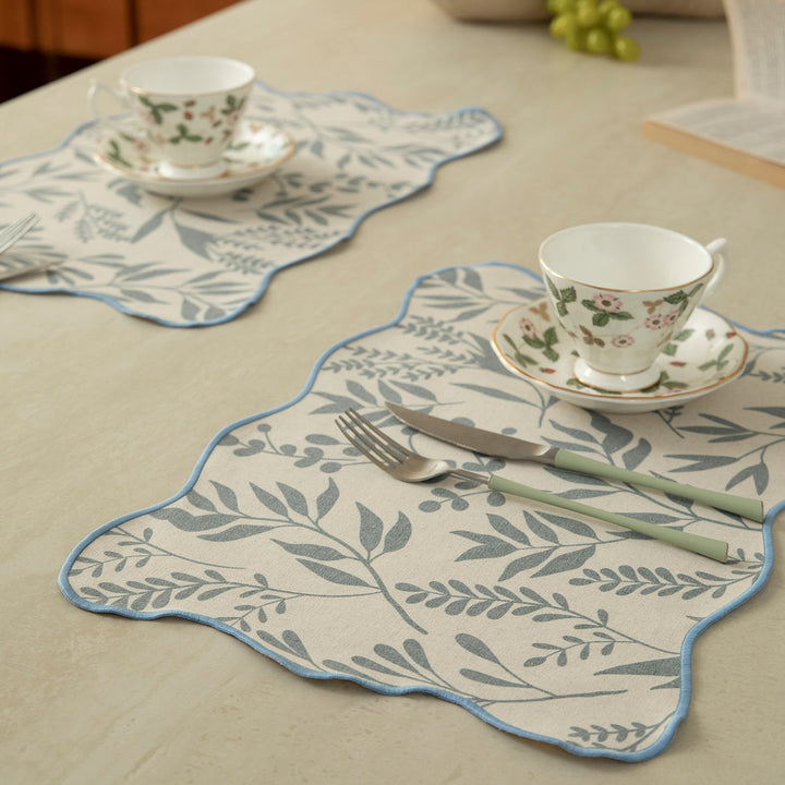 Shaped table set with curved contour and botanical leaf pattern Stornfield