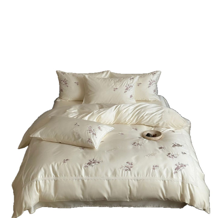 Satin bedding set with subtly embroidered flowers and lace trim