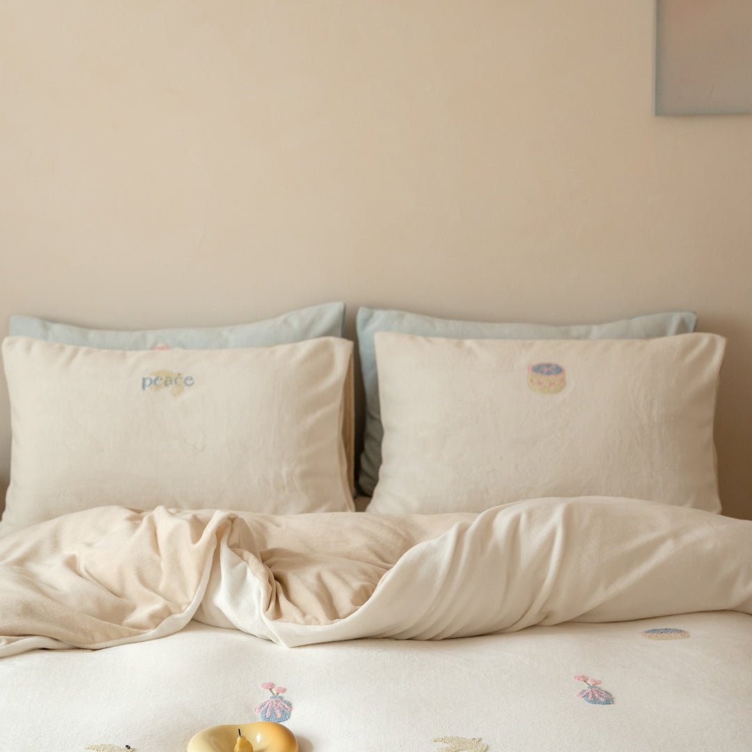 Bedding set with embroidered motif details, pompom trim and soft woven cotton finish