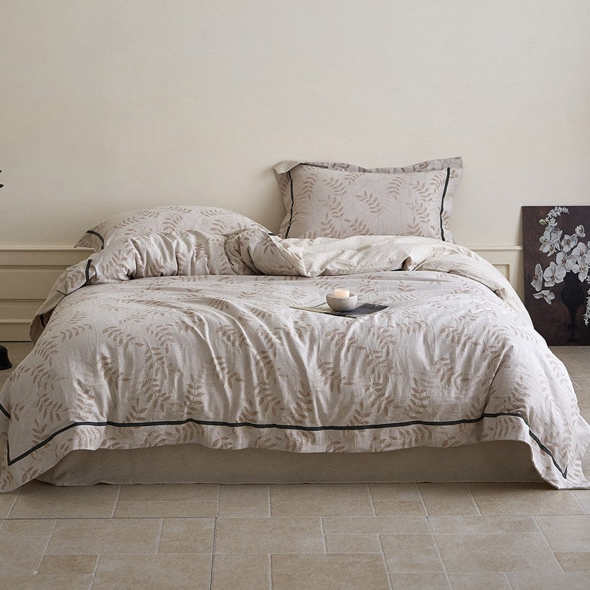 Linen bedding set with woven texture and subtle indigo border