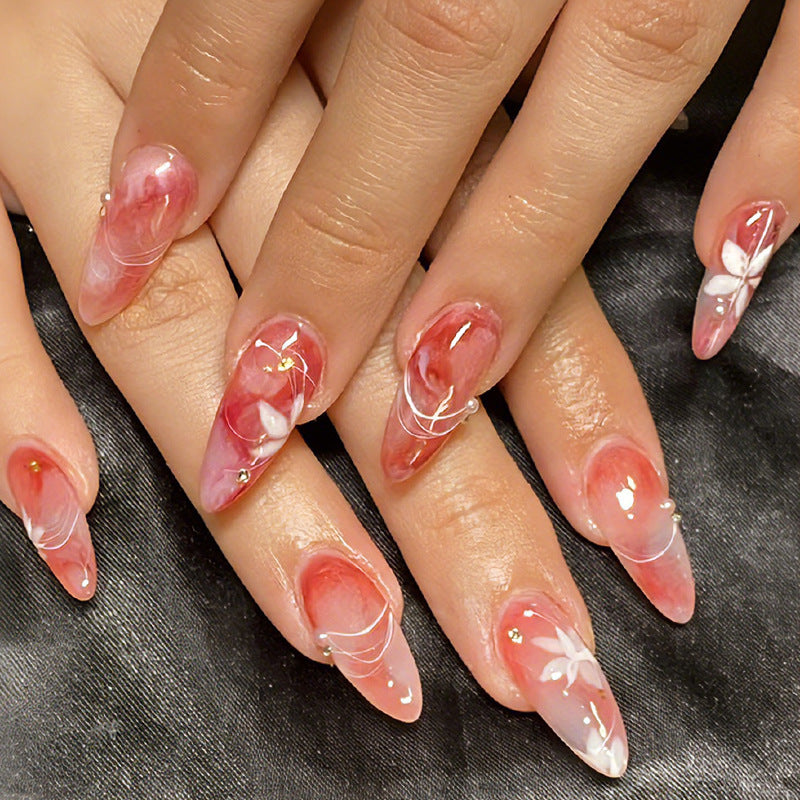 Acrylic nail set with elegant ombre design and floral accent Stornfield