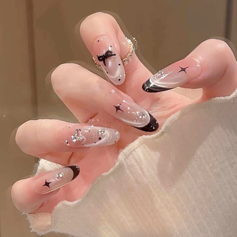 Nail art set with elegant black and white design and sparkling applications Stornfield