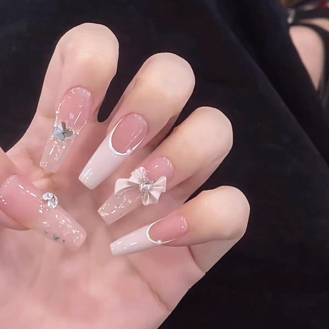Artificial nails with glitter accents and playful motifs Stornfield