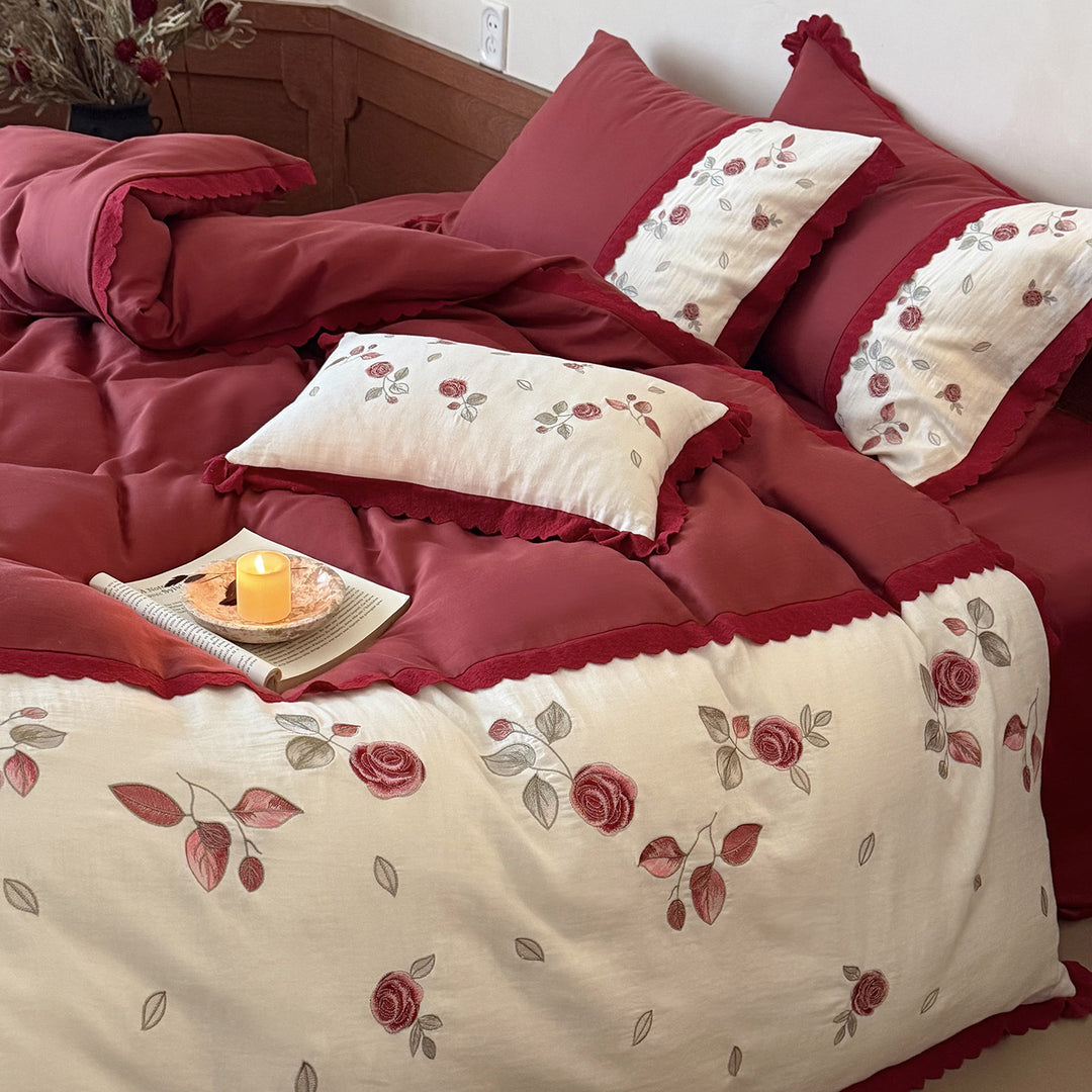 Bedding set with embroidered rose motif, ruffle and reversible feature
