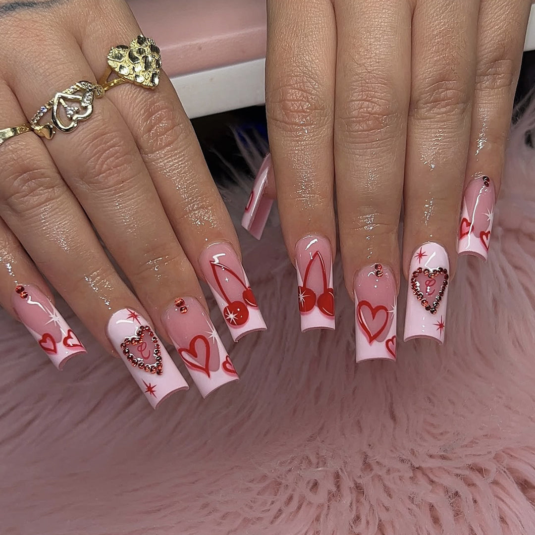 Artificial nail set with romantic heart designs and sparkling rhinestone decorations Stornfield