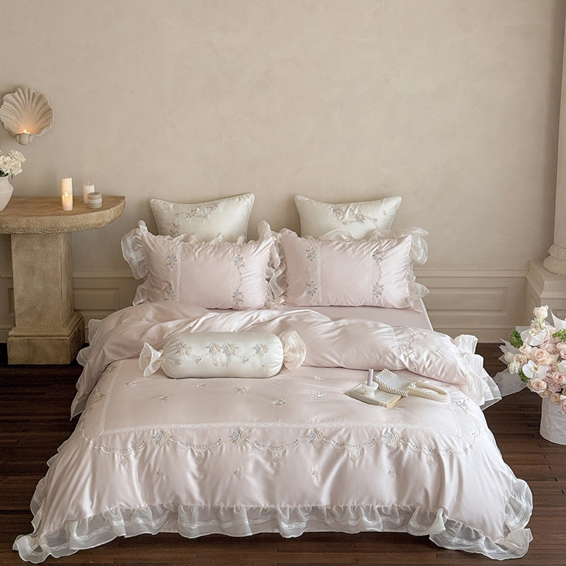 Satin bedding set with fine ruffle trim, delicate floral embroidery, and decorative pillowcases