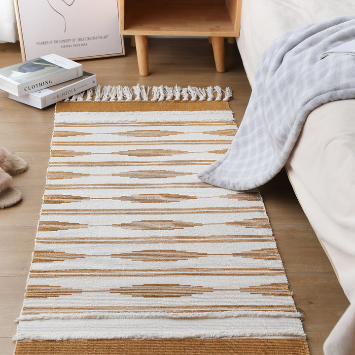 Flat Boho runner rug made of cotton blend fabric with geometric hexagon tufting and decorative fringed edge.