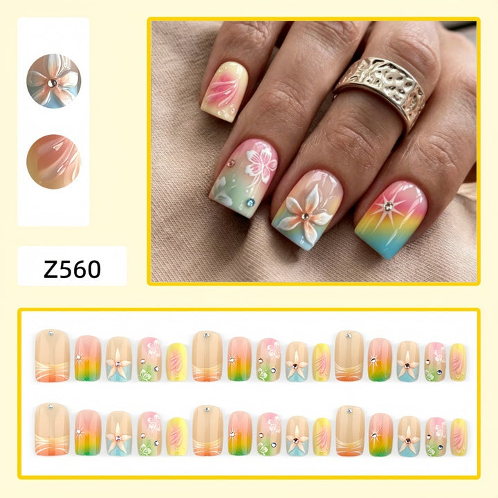 Artificial nails in vibrant floral design with glitter accents Stornfield