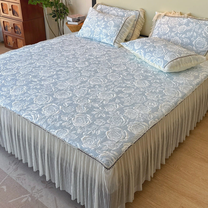 Quilted mattress and pillow set with butterfly motif and pleated bed ruffle