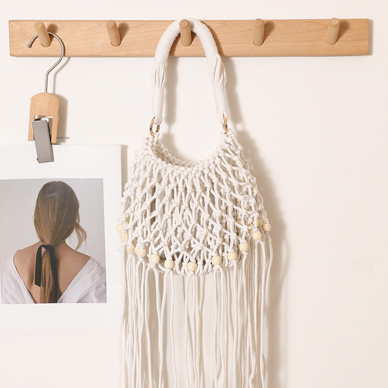 Macrame bag with decorative fringes and wooden beads Stornfield